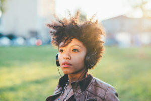 Half length of young beautiful afro curly hair woman listening m